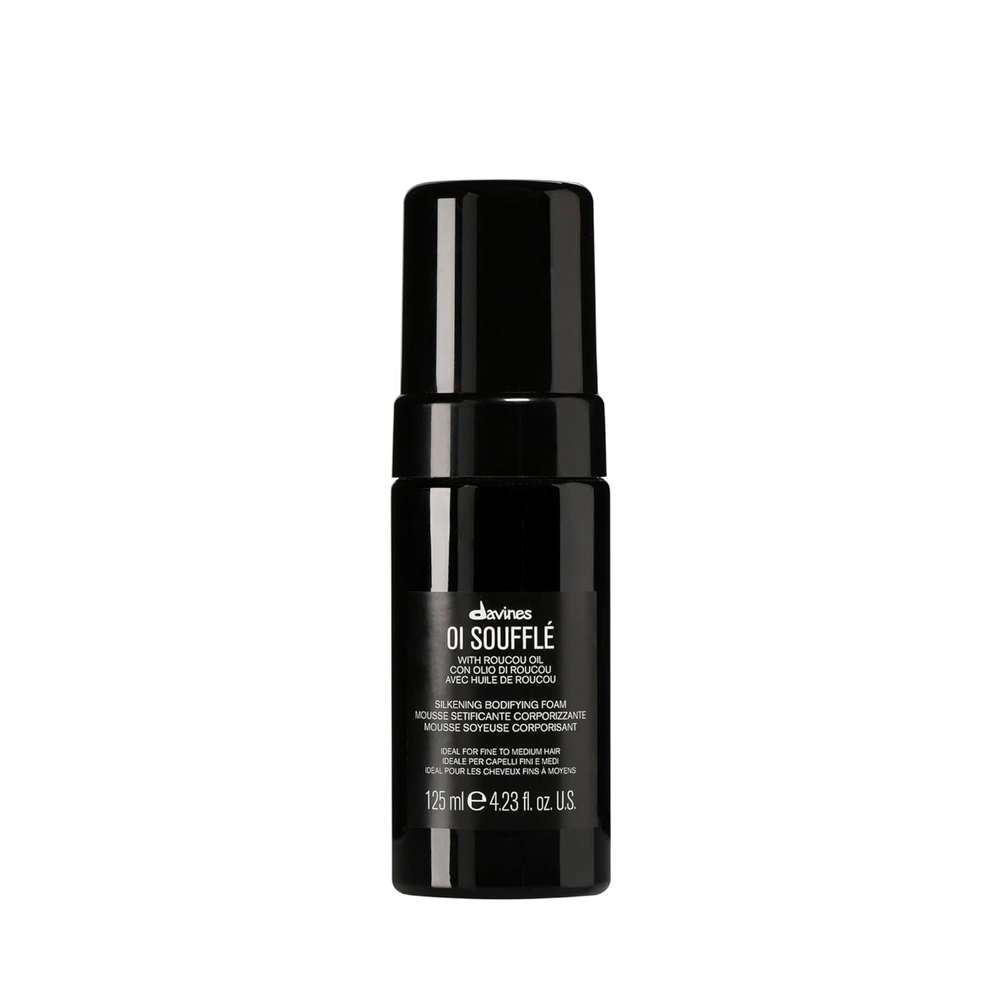 Black bottle of Davines OI Souffle on a white background