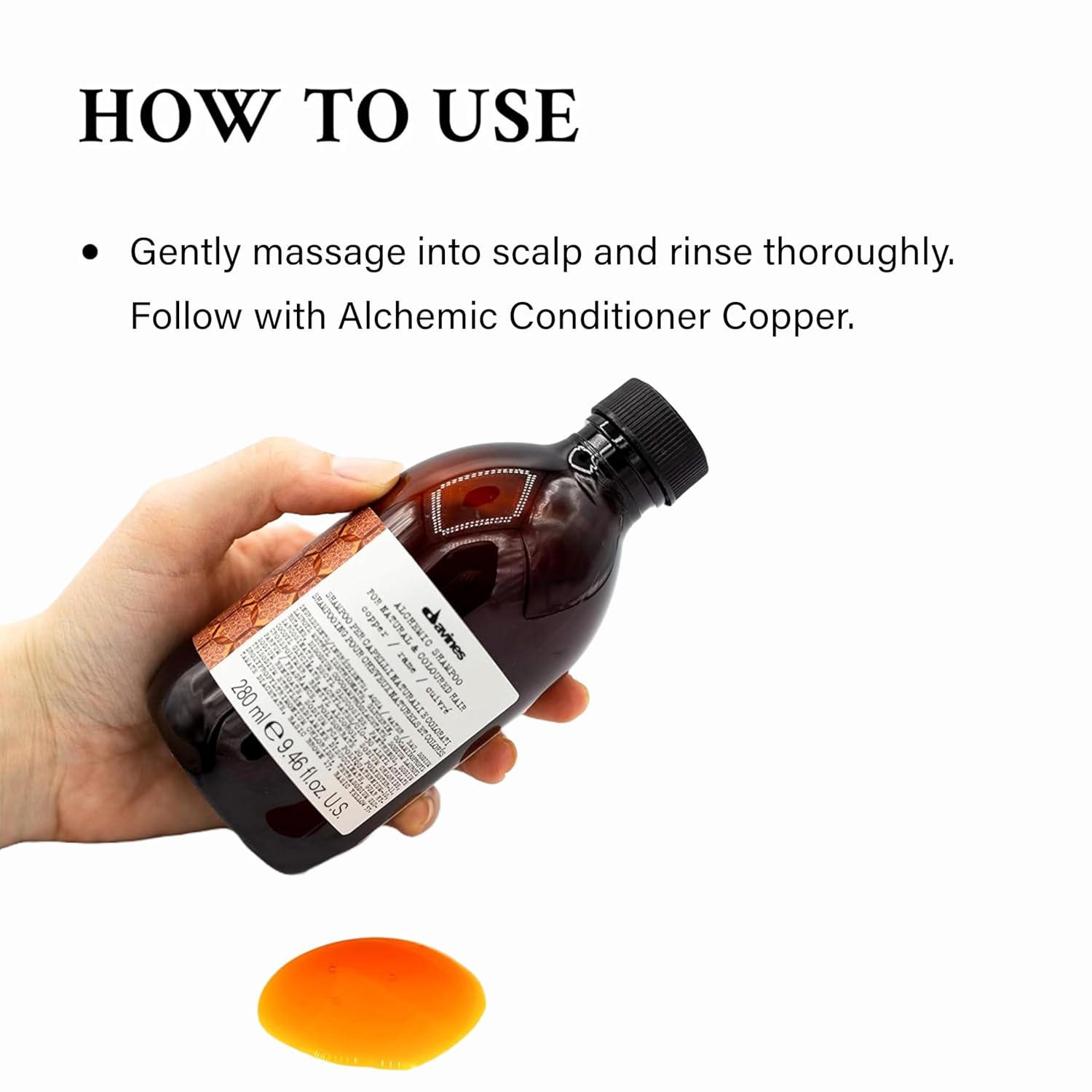 Davines Alchemic Shampoo Copper. Hand holding a bottle of hair care product with usage instructions on a white background