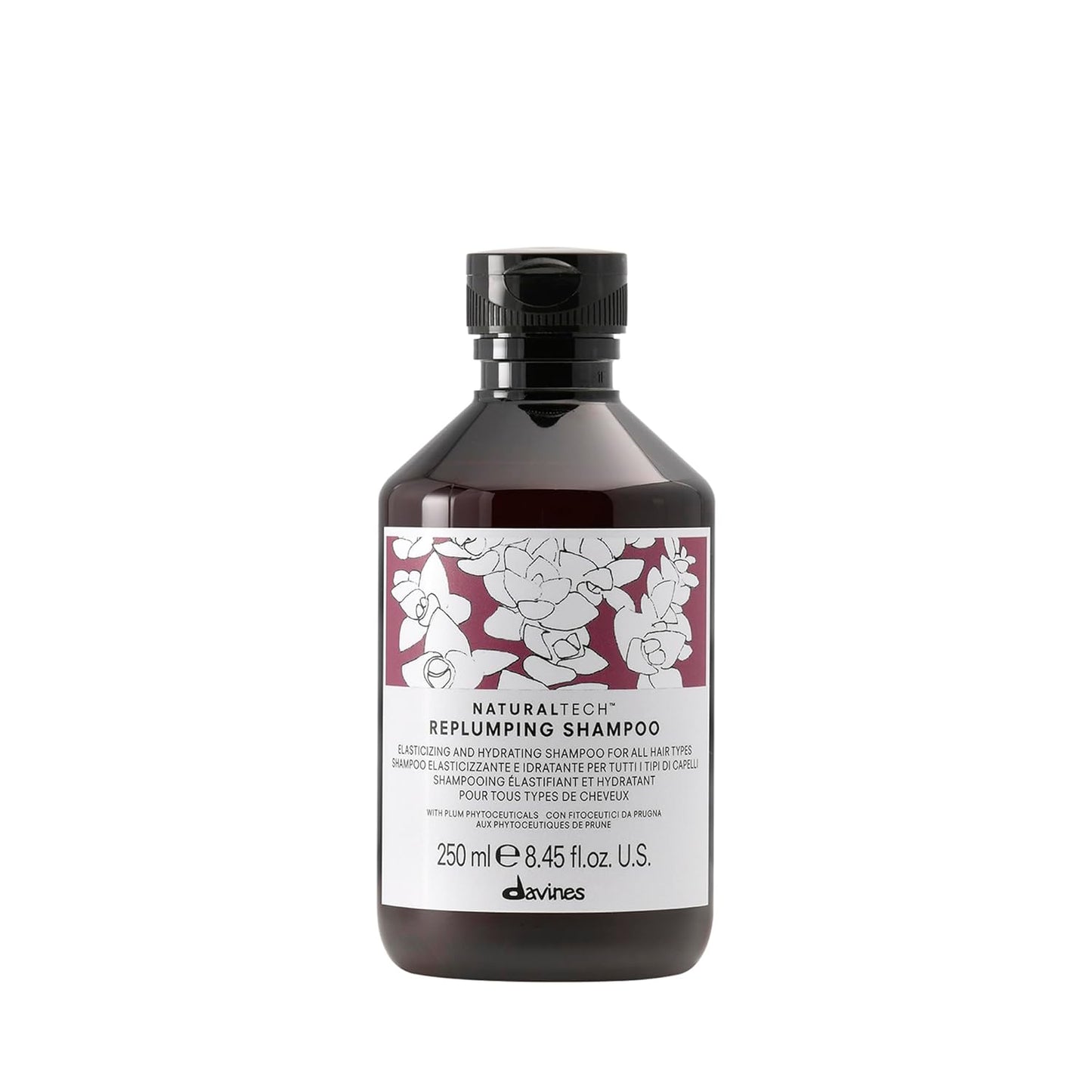 Bottle of Davines Naturaltech Replumping Shampoo with floral label on a white background
