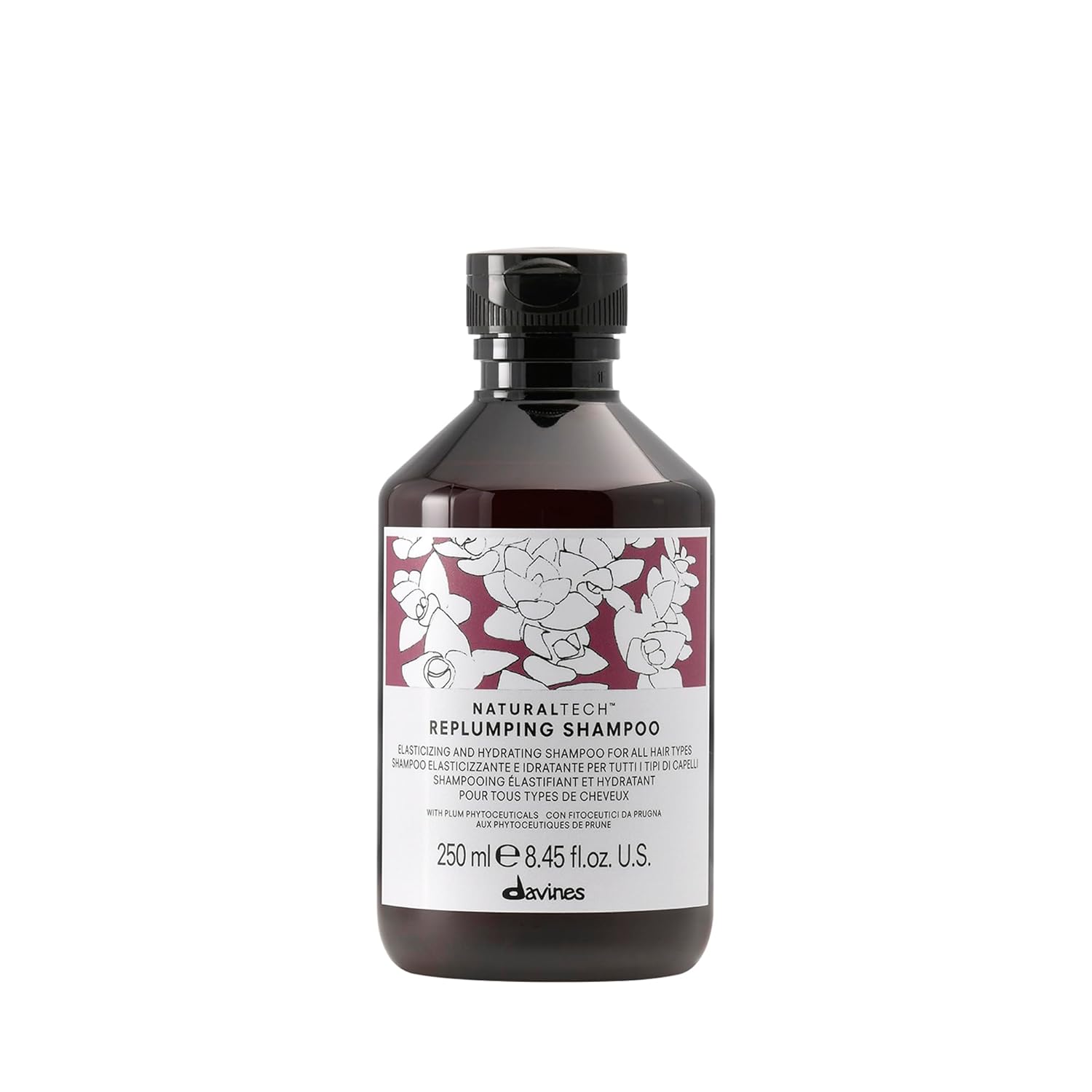 Bottle of Davines Naturaltech Replumping Shampoo with floral label on a white background
