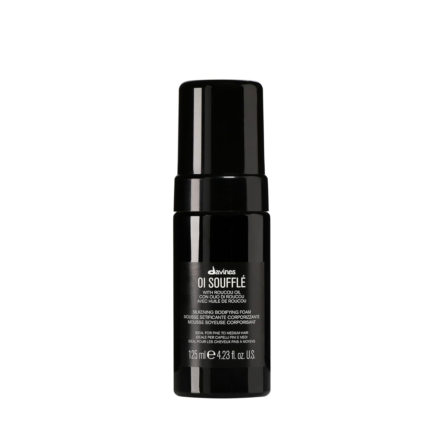 Black bottle of Davines OI Souffle on a white background