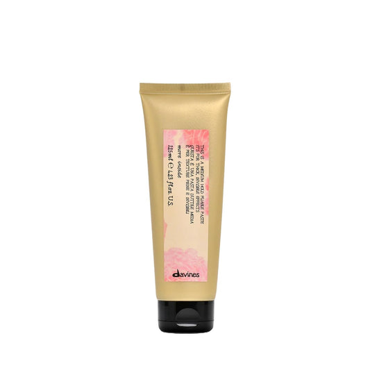 Davines This Is A Medium Hold Pliable Paste. Gold tube with pink label on a white background
